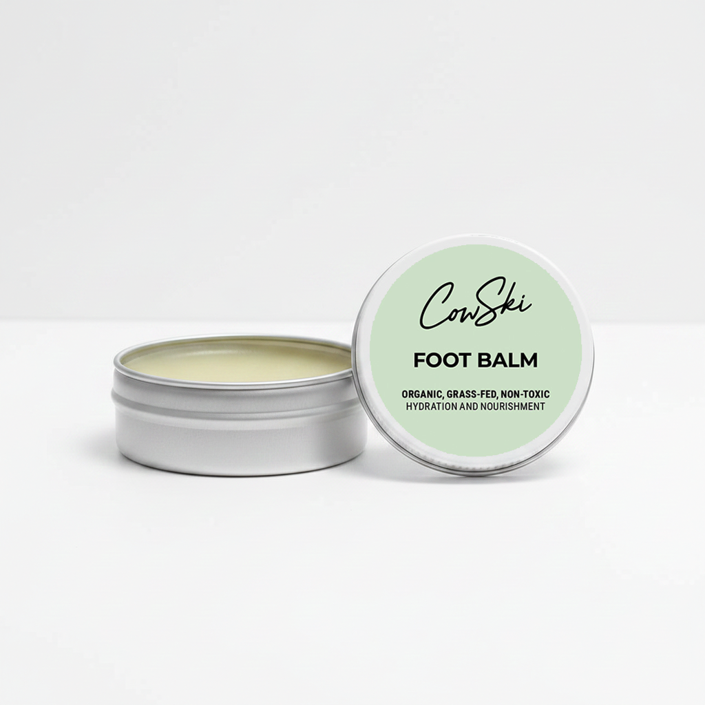 Tallow foot balm in a metal tin with a green lid on a white background