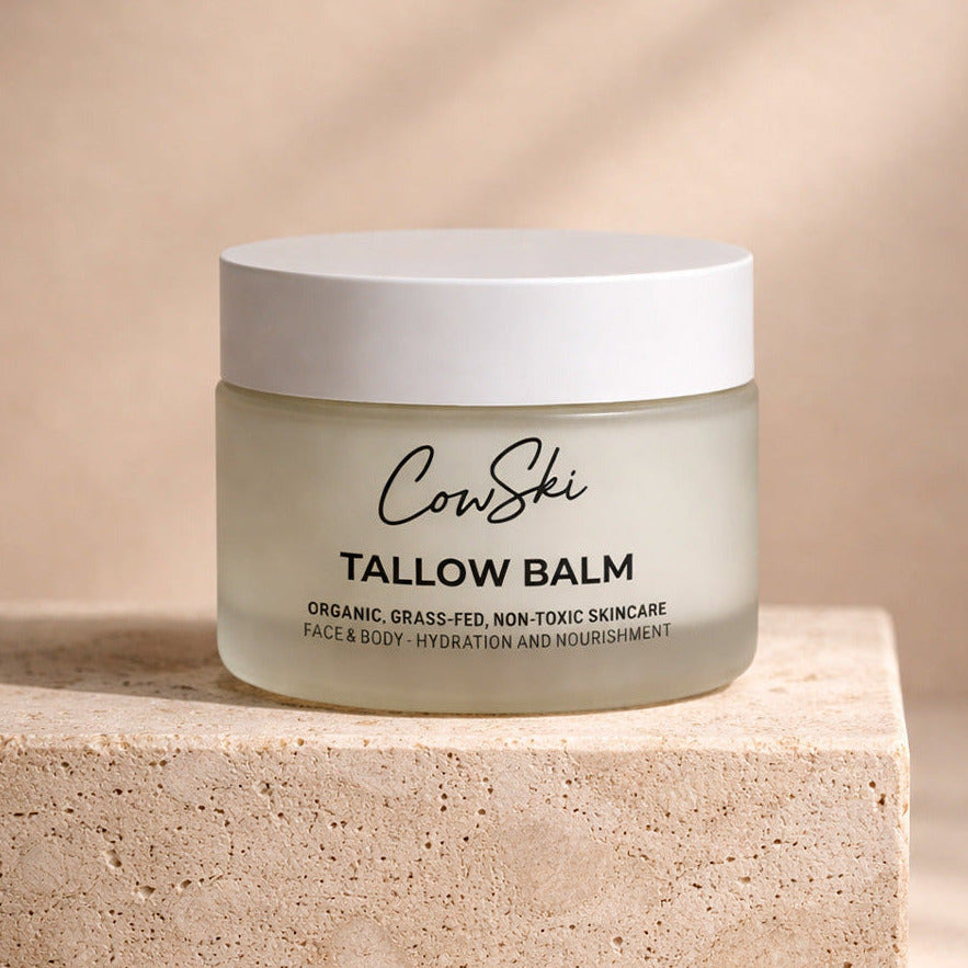 Jar of CowSki tallow balm on a beige background